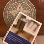 Image of dyslexia handbook with seal of Oklahoma in background